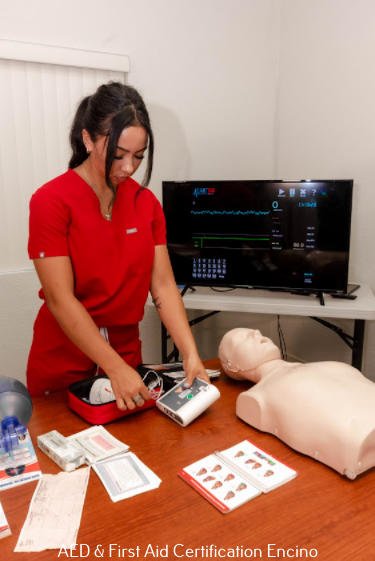 a female nurse attendant preparing the automated external defibrillator to revive an old man experiencing a cardiac arrest