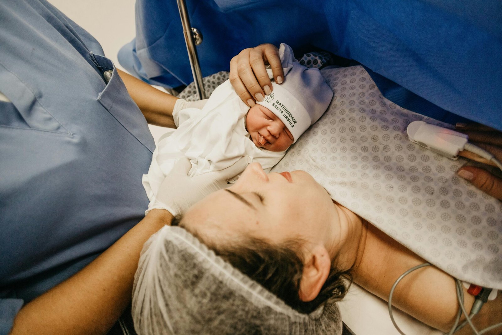 a newborn baby held by the nurse after the neonatal resuscitation program